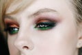 Closeup photo of opened woman eye with beautiful bright makeup, brown and green smoky eyes looking right side Royalty Free Stock Photo