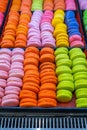 Closeup photo of pile of multicolored macaroon cakes at bakery