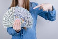 Closeup photo portrait of confident satisfied she her businesspeople holding pile of money in hand demonstrating indexing with