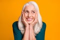 Closeup photo of pretty cheerful white haired grandma aged lady overjoyed arms on cheeks affectionate look side empty Royalty Free Stock Photo