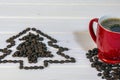 Red cup of coffee and christmas tree made of coffee beans, copy space image