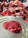 Closeup photo of red meat piece slice isolated, partially blurred background meat