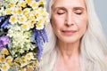 Closeup photo of retired white hair woman eyes closed enjoy smell bunch wild flowers inspiration isolated grey color