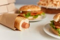 Closeup photo of sandwich, pasta in plate, sausage in dough, fast food dinner, delicious junk dish on table, background image