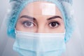 Closeup photo of serious infection disease doctor lady face surgery operation process wear medical respirator mask