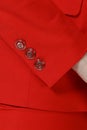 Closeup photo sleeve detail with buttons on red formal suit