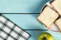 Sliced toast bread with butter and green apple on blue wooden table, top view of minimalist  breakfast, copy space image Royalty Free Stock Photo