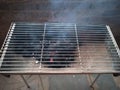 Closeup of a charcoal fire burning hot red coals with a grill cover Royalty Free Stock Photo