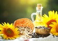 Closeup photo of sunflowers and sunflower oil with seeds on on a wooden table. Bio and organic concept of the product. Royalty Free Stock Photo