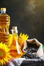 Closeup photo of sunflowers and sunflower oil with seeds on on a wooden table. Bio and organic concept of the product. Royalty Free Stock Photo