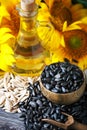 Closeup photo of sunflowers and sunflower oil with seeds on on a wooden table. Bio and organic concept of the product. Royalty Free Stock Photo