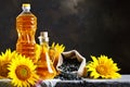 Closeup photo of sunflowers and sunflower oil with seeds on on a wooden table. Bio and organic concept of the product. Royalty Free Stock Photo