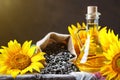 Closeup photo of sunflowers and sunflower oil with seeds on on a wooden table. Bio and organic concept of the product. Royalty Free Stock Photo