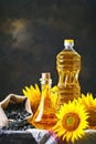 Closeup photo of sunflowers and sunflower oil with seeds on on a wooden table. Bio and organic concept of the product. Royalty Free Stock Photo