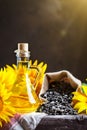 Closeup photo of sunflowers and sunflower oil with seeds on on a wooden table. Bio and organic concept of the product. Royalty Free Stock Photo