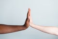 Closeup photo of two arms clap giving five different race multinational relationship antiracism issue help together