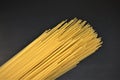 Closeup photo of uncooked spagetti pasta isolated on black background.