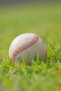 Closeup image of a baseball on a field in grass Royalty Free Stock Photo