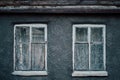 Closeup photo of wall of gray buildnig with vintage windows. Royalty Free Stock Photo