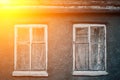 Closeup photo of wall of gray buildnig with vintage windows. Royalty Free Stock Photo