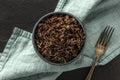 A closeup photo of wild black rice, shot from above on a black background Royalty Free Stock Photo