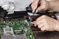 Woman engineer replace computer part from notebook motherboard Royalty Free Stock Photo