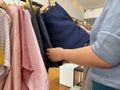 Closeup photo of woman hands choosing skirt at clothing store Royalty Free Stock Photo