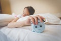 Closeup photo of woman turning off alarm clock Royalty Free Stock Photo