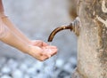 Closeup photo of woman washing hands in a city fountain Royalty Free Stock Photo