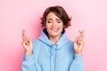 Closeup photo of young adorable pretty cute nice woman wear blue hoodie crossed fingers dreaming pray isolated on pink Royalty Free Stock Photo