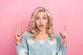Closeup photo of young astonished funny girl curly hair shocked pointing fingers mockup bad news reaction isolated on