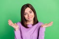 Closeup photo of young attractive lady shrug shoulders dont know answer assistant isolated on green color background