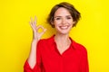 Closeup photo of young employer businesswoman wear red shirt showing okey sign toothy smile good job isolated on yellow
