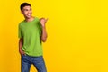 Closeup photo of young hansome smiling positive guy wear green t-shirt look directing finger empty space ad isolated on