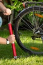 Closeup image of young man pumping flat bicycle tire Royalty Free Stock Photo