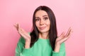 Closeup photo of young unsure confused woman wear green sweatshirt shrug shoulders no idea unsure choose product