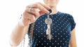 Closeup photo of young woman holding keys from new house and showing it in camera Royalty Free Stock Photo