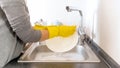 Closeup image of young woman washing dishes under flowing water Royalty Free Stock Photo