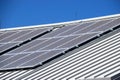 Closeup of photovoltaic solar power generation panels on the roof top against a clear blue summer sky in Arizona