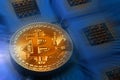 Closeup of physical bitcoin over computer cpu processors aligned. Royalty Free Stock Photo