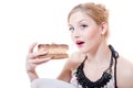 Closeup picture of blue eyes beautiful blond young woman having fun eating alone large chocolate cake happy smiling Royalty Free Stock Photo