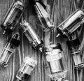 Closeup picture with different generations of electronic vacuum tubes in black and white.