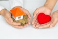 Closeup picture of female hands holding model house and red heart. charity, real estate and family home concept Royalty Free Stock Photo