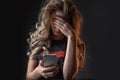 Closeup picture of frustrated girl, young woman being a victim of bullying online Royalty Free Stock Photo