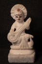 Closeup picture of Goddess Saraswati idol made by white stone isolated on black background, devi Saraswati considered as the