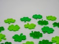 Closeup picture of green decorative shamrocks against a grey background