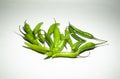 Closeup picture of green thin pepper on a white isolated background with shadows