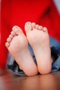 Closeup picture of kid feet with smiley faces painted toes. Royalty Free Stock Photo