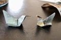 Closeup picture of origami birds made from money, banknotes. Euros on the textured table Royalty Free Stock Photo