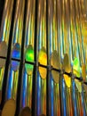 Closeup picture of the pipes of church organ with the rainbow play of colors. Royalty Free Stock Photo